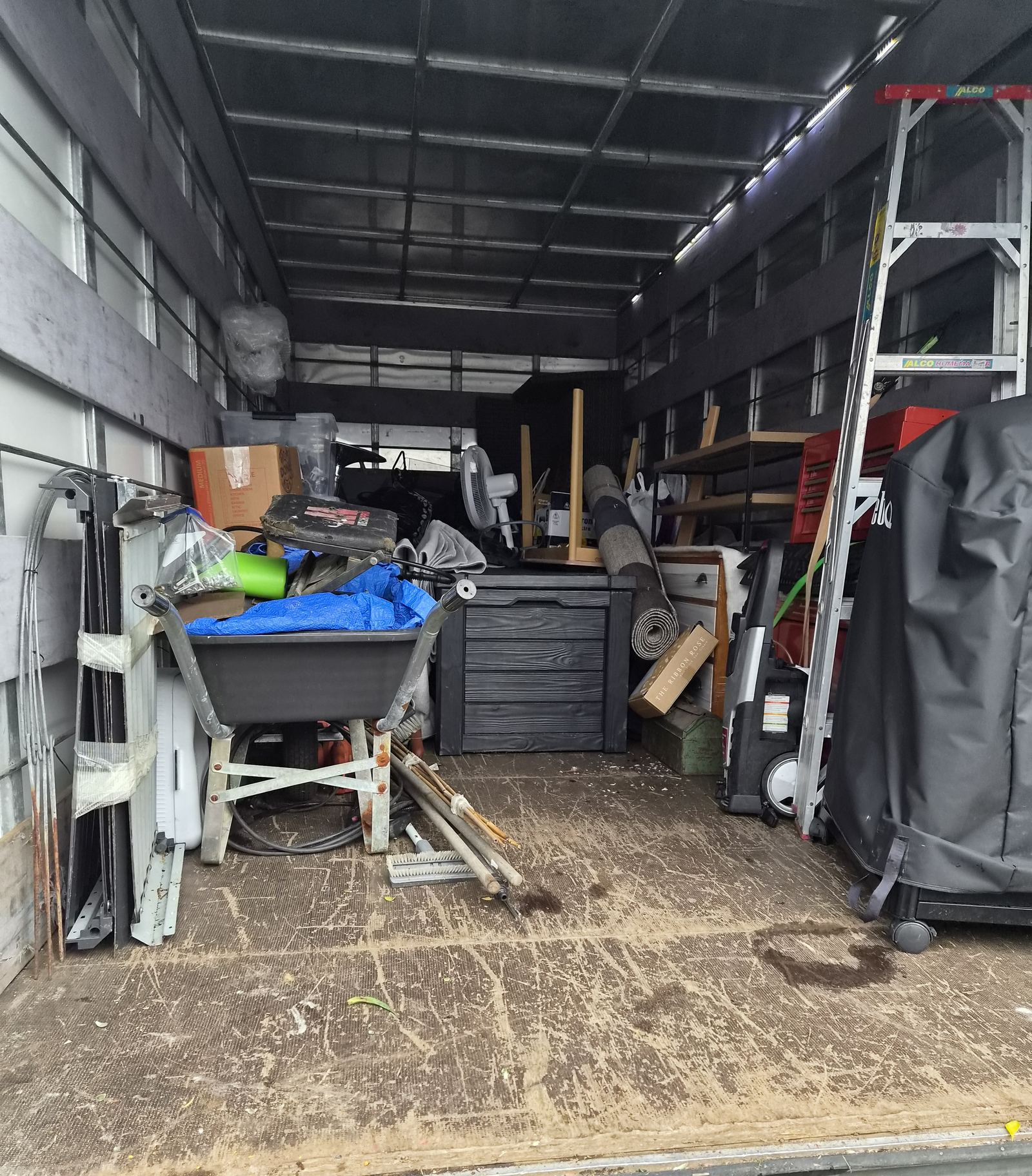 Garden gear, a ladder and garage overflow loaded into the First Light Movers truck